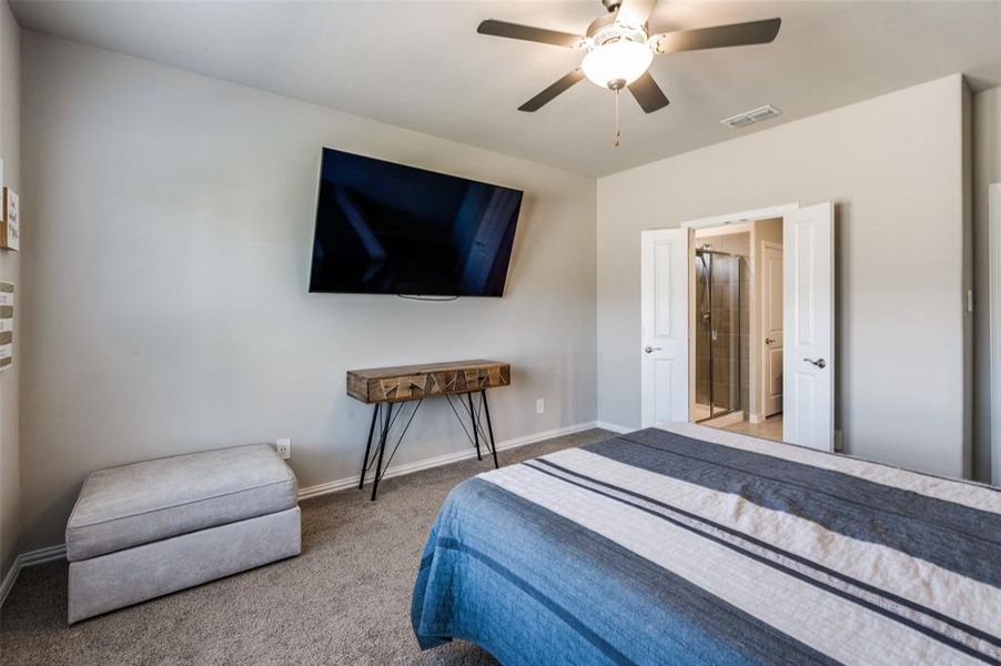Bedroom featuring a ceiling fan and light colored carpet