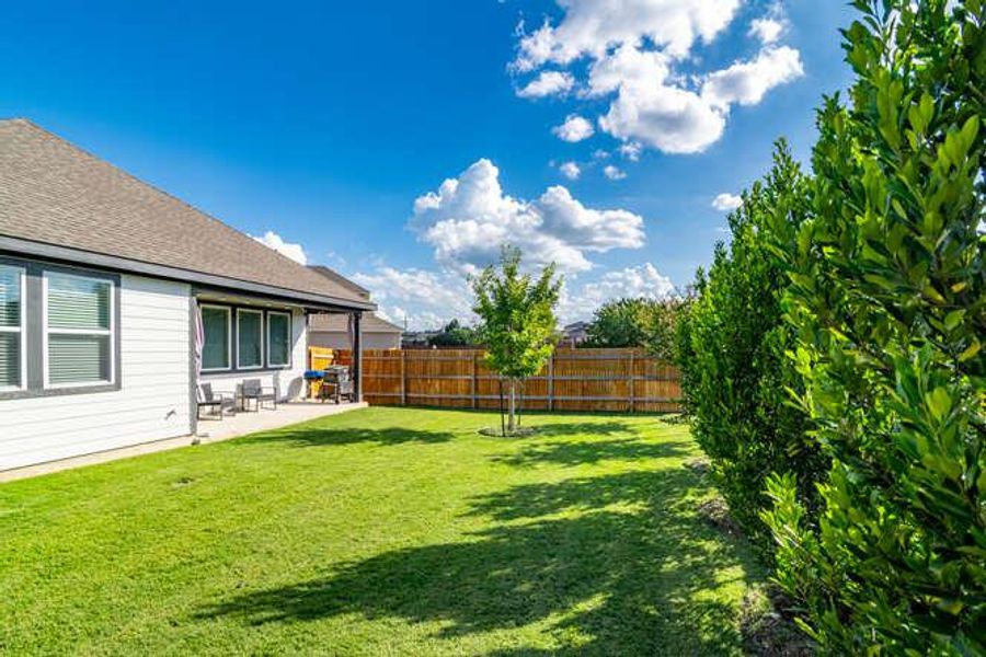 Fenced backyard featuring a patio area