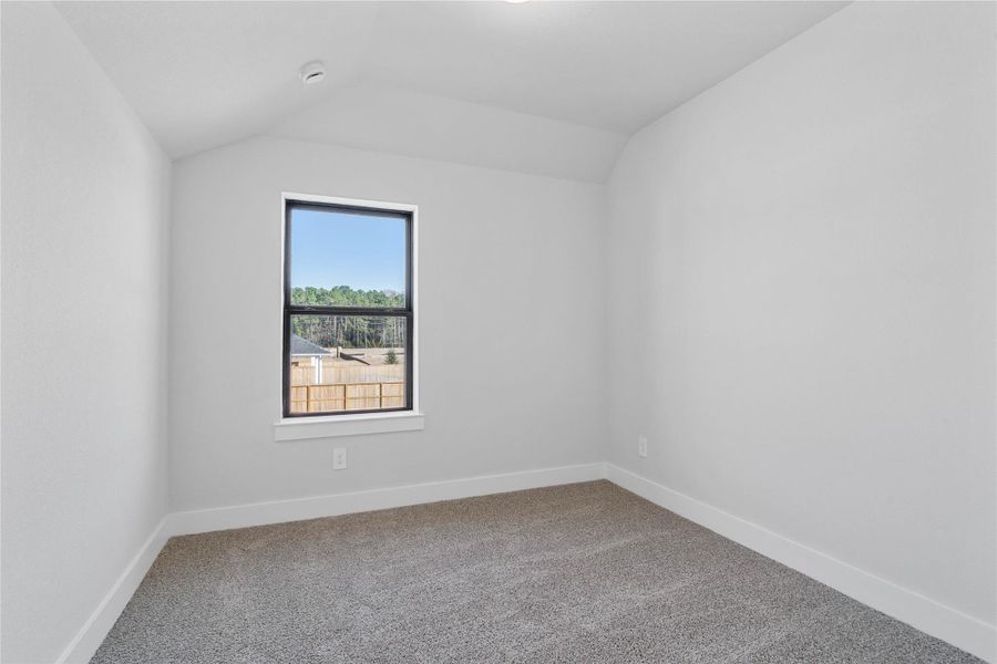 Discover a peaceful sanctuary in this inviting secondary bedroom, perfectly designed for comfort. It features sloped ceiings and a generously sized window providing ample natural light. Discover a peaceful sanctuary in this inviting secondary bedroom, perfectly designed for comfort. It features sloped ceiings and a generously sized window providing ample natural light.