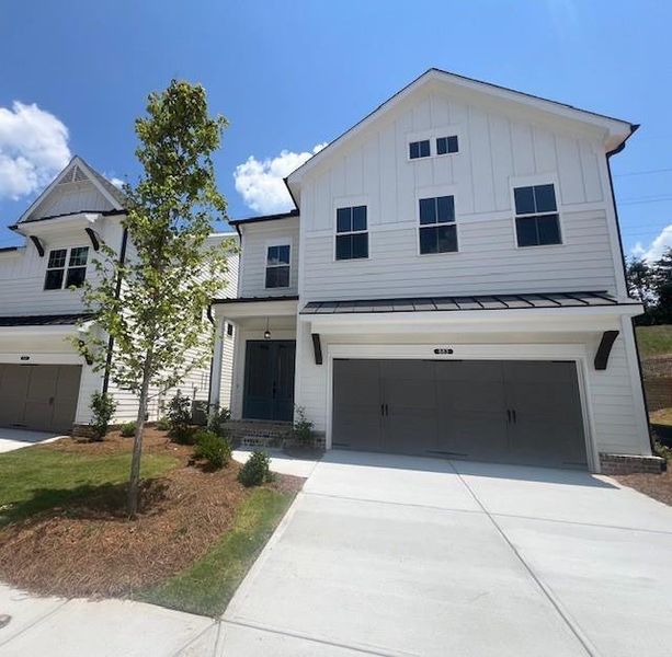 Front exterior of a new home in Palisades Single Family, Cumming, GA, highlighting curb appeal (Image 24).