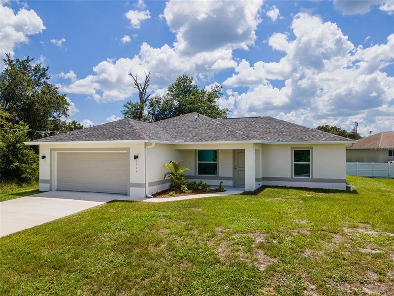 Front exterior of a new home in , Lehigh Acres, FL, highlighting curb appeal (Image 1). Front exterior of a new home in , Lehigh Acres, FL, highlighting curb appeal (Image 1).