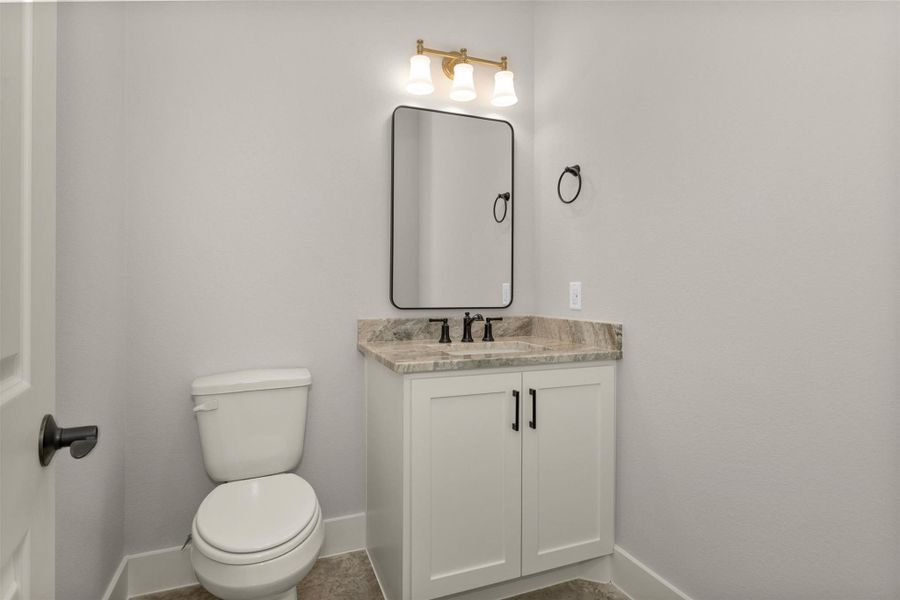 Conveniently located just down the hall from the living room and kitchen, the half bath is perfectly positioned for guests. This thoughtfully placed powder room offers both privacy and accessibility, making it ideal for entertaining.