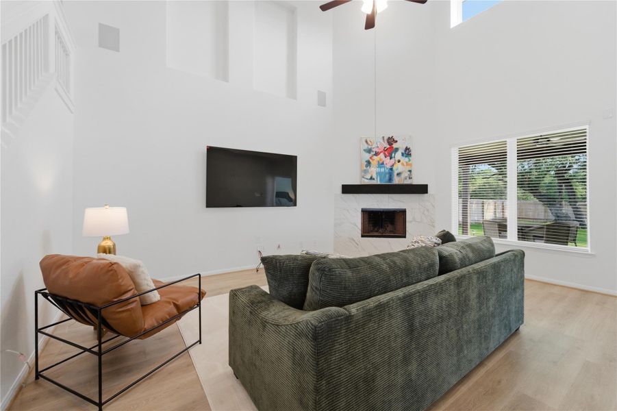 A striking fireplace and abundant natural light define this inviting great room. A striking fireplace and abundant natural light define this inviting great room.