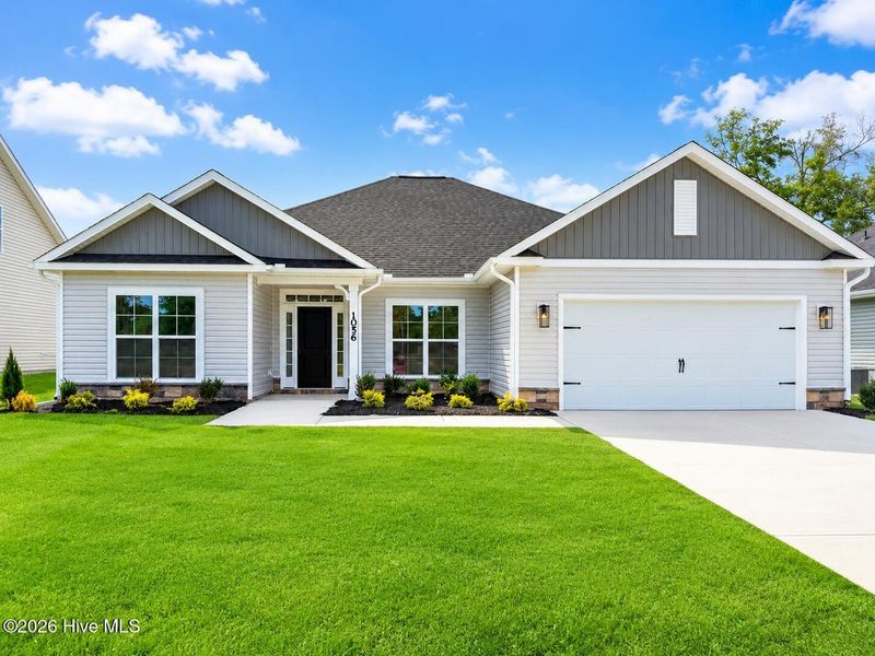 Front exterior of a new home in Wood Creek Landing, Leland, NC, highlighting curb appeal (Image 2). Front exterior of a new home in Wood Creek Landing, Leland, NC, highlighting curb appeal (Image 2).