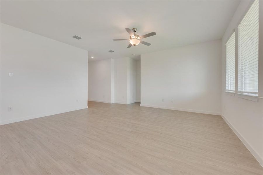 Empty room featuring ceiling fan and light hardwood / wood-style flooring