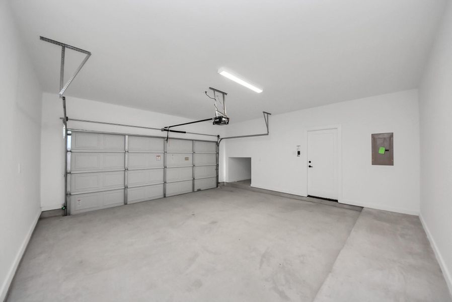 The garage is bright, spacious, and practical, featuring modern automatic doors and interior access, offering both convenience and secure storage for vehicles or hobbies.