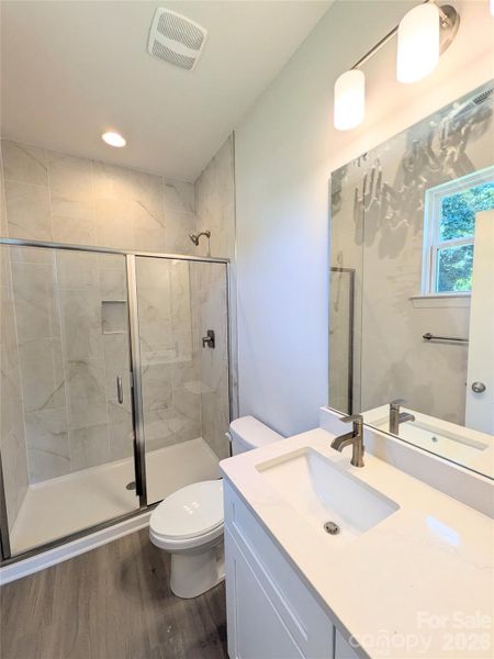 Tiled shower in primary Bedroom