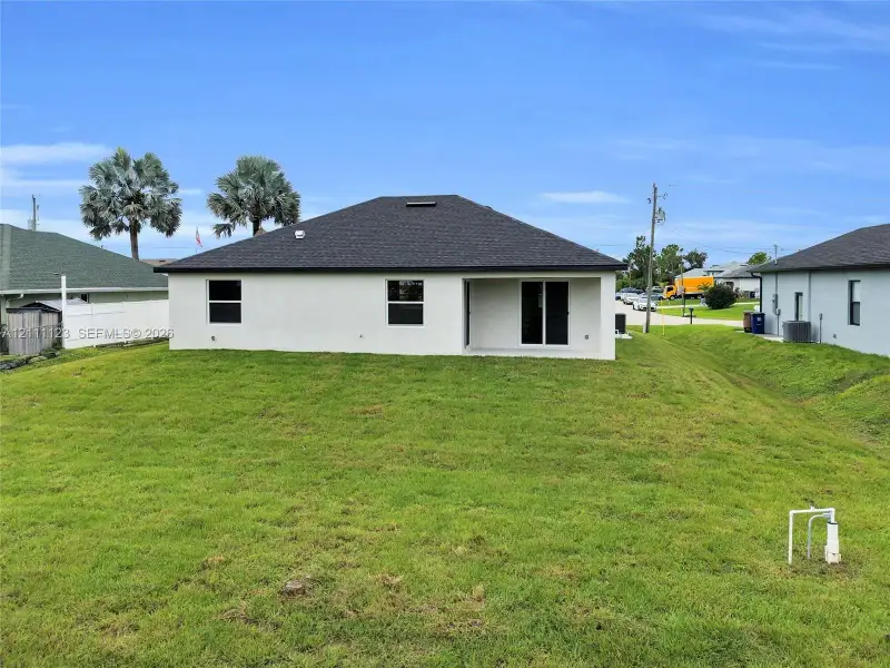 Rear exterior with lanai and sliding glass doors.
