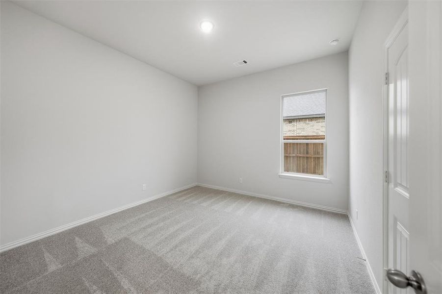 Carpeted spare room with baseboards Carpeted spare room with baseboards