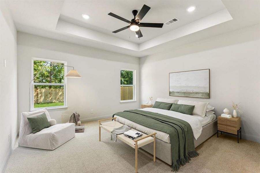Bedroom with a tray ceiling, multiple windows, carpet, a ceiling fan, and recessed lighting