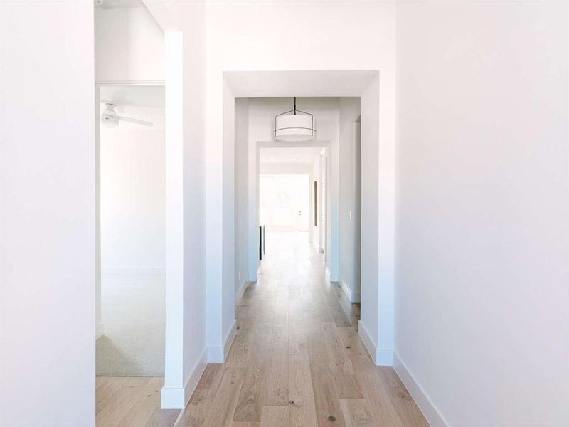 Corridor with light hardwood / wood-style flooring