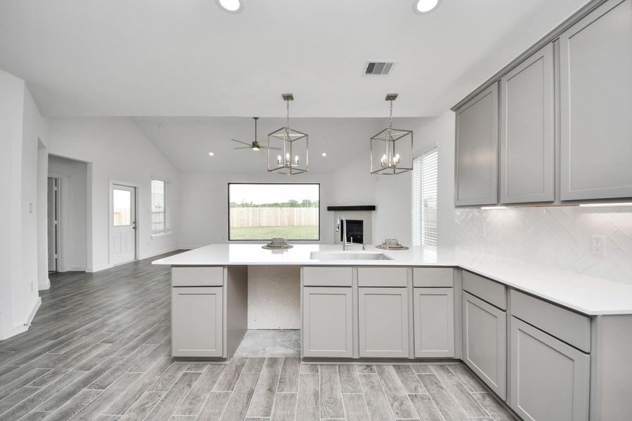 All of this overlooks your expansive family room, creating a perfect space for culinary delights and family gatherings. Sample photo of completed home with similar floor plan. Actual colors and selections may vary.