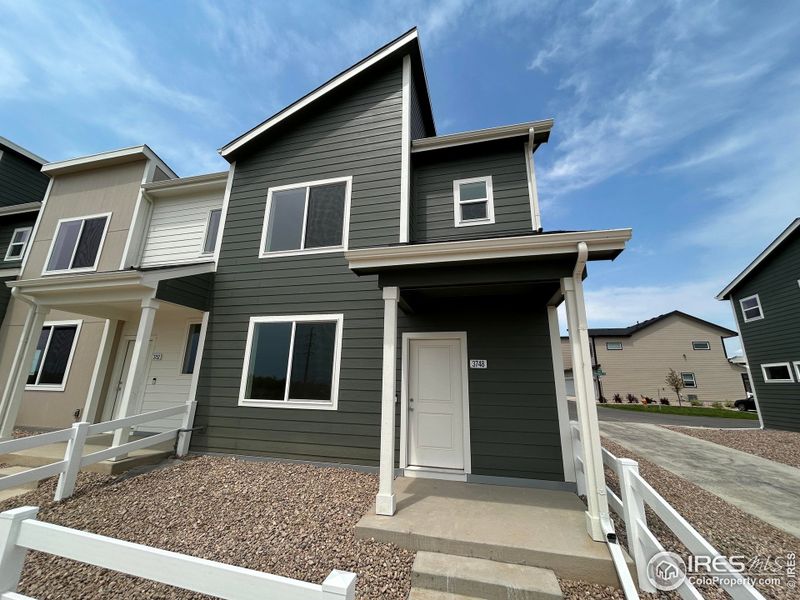 Front exterior of a new home in Liberty Draw, Evans, CO, highlighting curb appeal (Image 2).