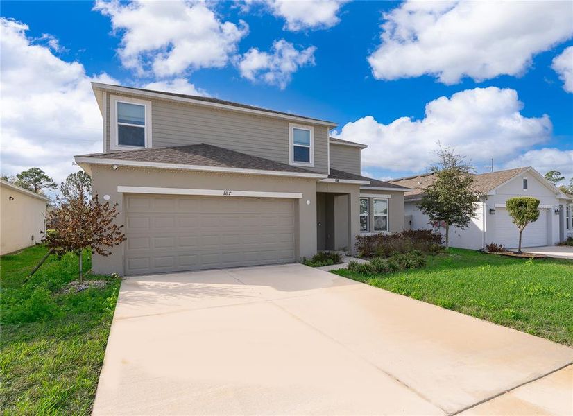Front exterior of a new home in Marion Creek, Haines City, FL, highlighting curb appeal (Image 2). Front exterior of a new home in Marion Creek, Haines City, FL, highlighting curb appeal (Image 2).