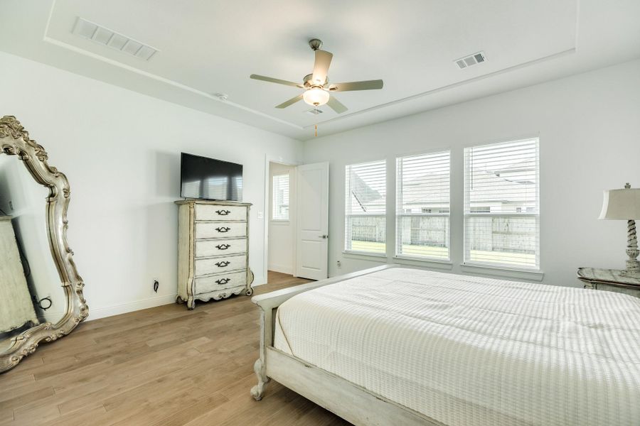 This view shows the open floor plan with plenty of room to organize your primary suite, highlighting the expansive layout and natural light that flows throughout the space. The architectural design allows for versatile furniture placement, ensuring both comfort and functionality