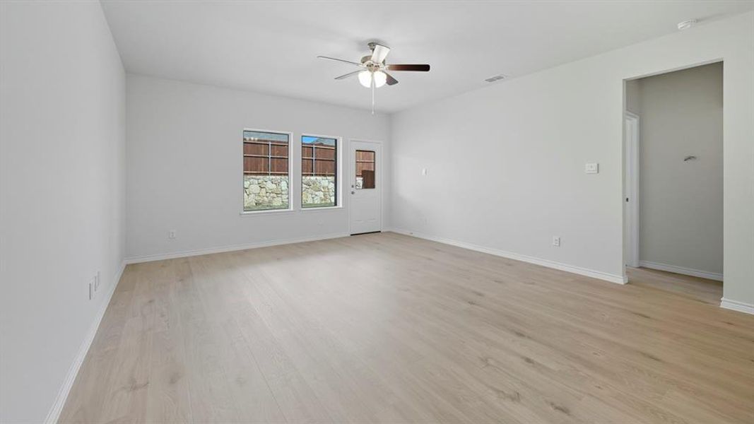 Empty room with light wood-style floors and a ceiling fan Empty room with light wood-style floors and a ceiling fan