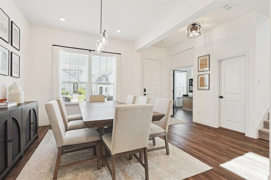 Dining area featuring dark wood-type flooring