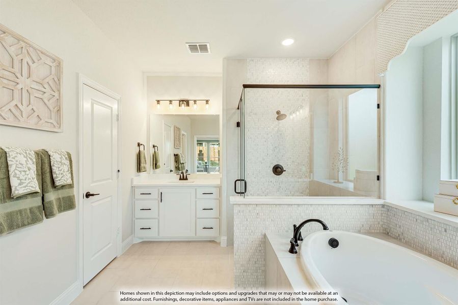 Master bathroom with white vanity, glass-enclosed shower, soaking tub, and mosaic tile walls