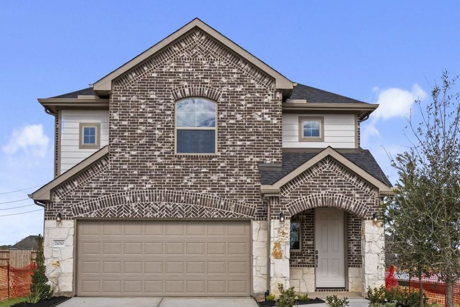Front exterior of a new home in Sorella, Tomball, TX, highlighting curb appeal (Image 1). Front exterior of a new home in Sorella, Tomball, TX, highlighting curb appeal (Image 1).