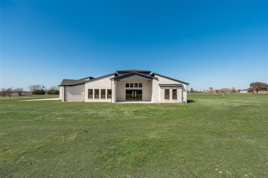 Back of house featuring a lawn