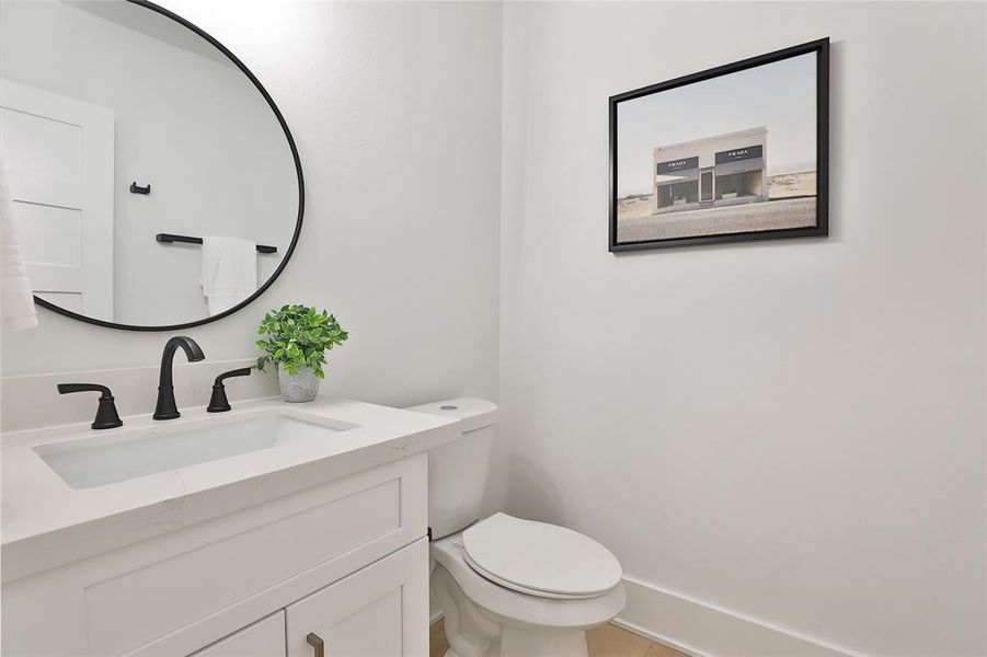 Conveniently located at the top of the stairs on the second floor, this elegant powder room offers both privacy and easy access for guests and family.