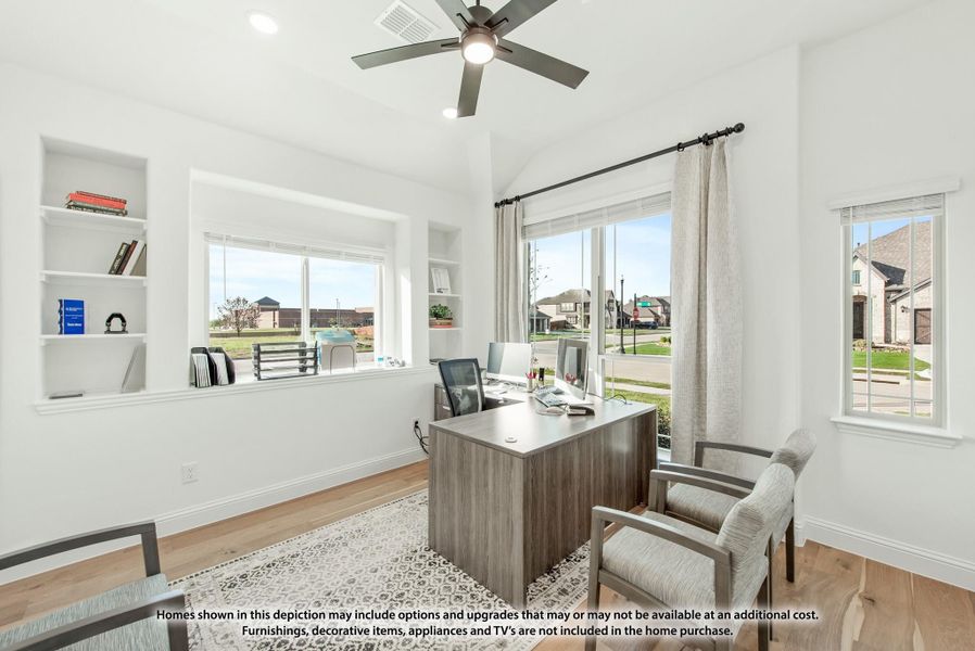 Home office with wood desk, built-in shelves, ceiling fan, and large windows with neighborhood views