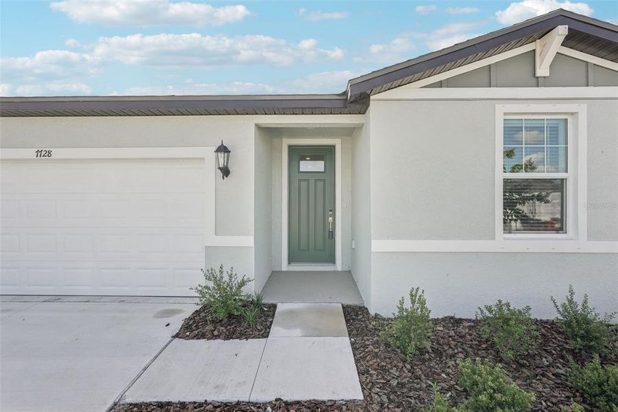 Front exterior of a new home in Salt Meadows - Classic Series, Parrish, FL, highlighting curb appeal (Image 14). Front exterior of a new home in Salt Meadows - Classic Series, Parrish, FL, highlighting curb appeal (Image 14).