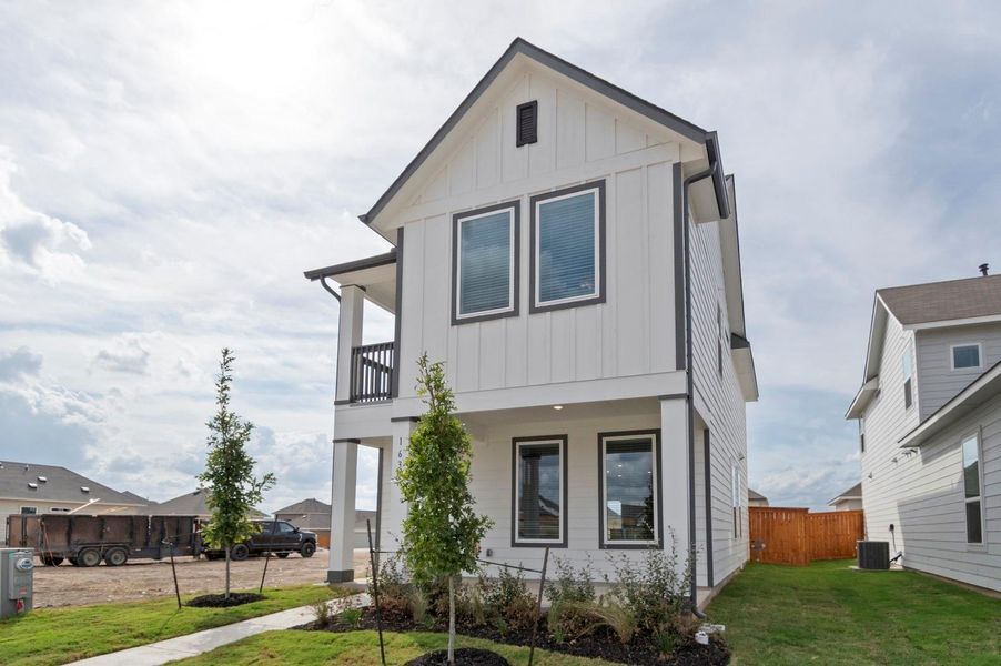 Front exterior of a new home in Trace, San Marcos, TX, highlighting curb appeal (Image 23).