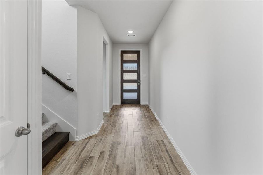 Doorway to outside featuring wood finished floors and recessed lighting