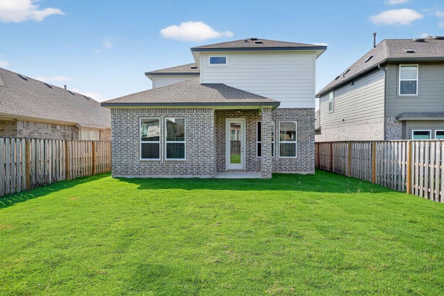 Rear view of property featuring a patio, a fenced backyard, a shingled roof, and brick siding Rear view of property featuring a patio, a fenced backyard, a shingled roof, and brick siding