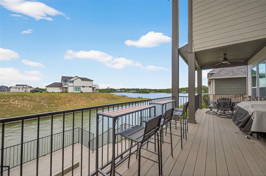 Entertainer’s dream with bar-height seating and multiple gathering zones, all oriented toward the water. Entertainer’s dream with bar-height seating and multiple gathering zones, all oriented toward the water.