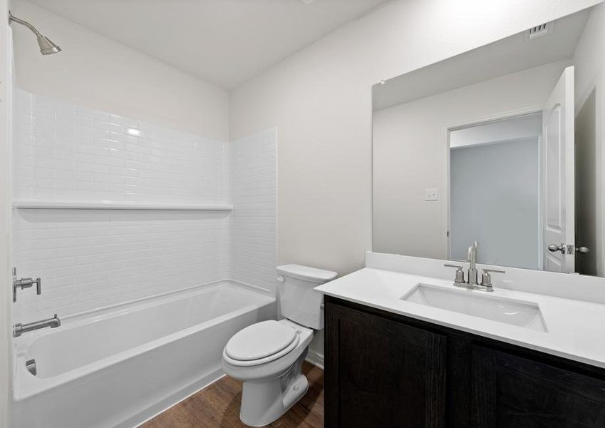 The secondary bathroom has a large vanity space.