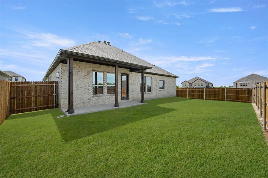 Back of house featuring a fenced backyard, a patio, a shingled roof, and brick siding Back of house featuring a fenced backyard, a patio, a shingled roof, and brick siding