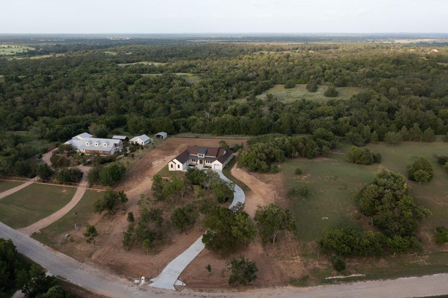 Aerial overview of property's location featuring a heavily wooded area and rural landscape Aerial overview of property's location featuring a heavily wooded area and rural landscape