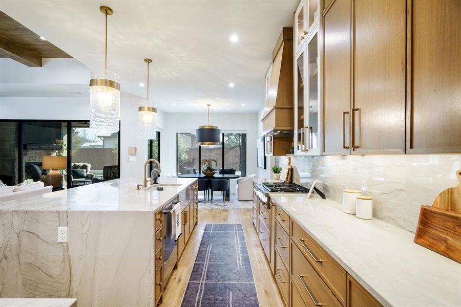 Kitchen featuring quartzite counterops and backsplash