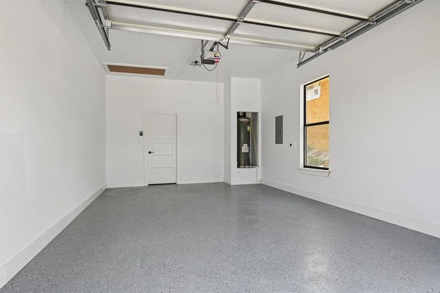 Garage with electric panel and water heater Garage with electric panel and water heater