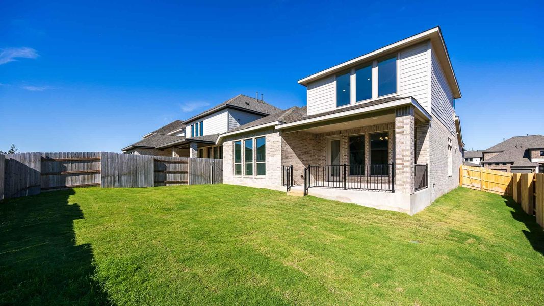 Rear view of property with brick siding, a patio, and a fenced backyard Rear view of property with brick siding, a patio, and a fenced backyard