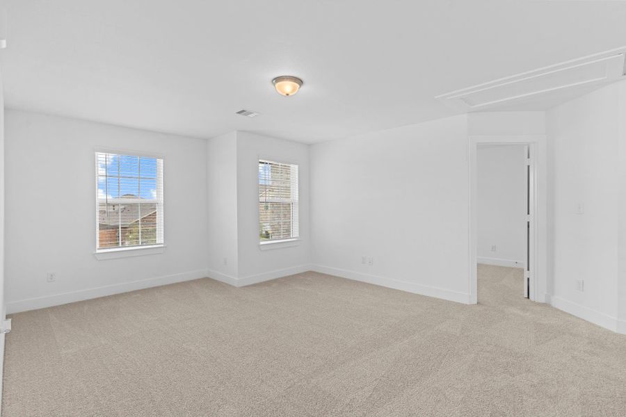 Another view of the upstairs game room reveals its generous size and flexible layout, with multiple windows for natural light and an open design that connects seamlessly to the adjacent hallway and secondary bedrooms—ideal for gatherings, movie nights, or play space. **Image Representative of Plan Only and May Vary as Built**.