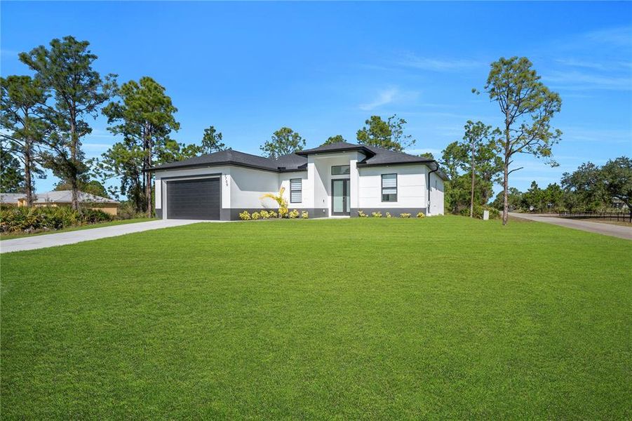 Front exterior of a new home in , Lehigh Acres, FL, highlighting curb appeal (Image 1). Front exterior of a new home in , Lehigh Acres, FL, highlighting curb appeal (Image 1).