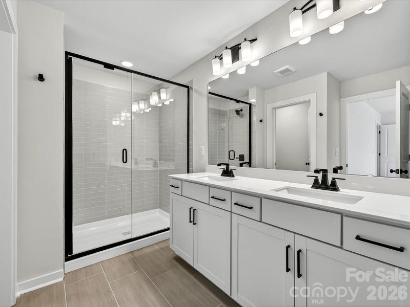 primary bath with large, tiled shower with bench, dual vanity with soft close doors & drawers, Quartz countertops. Separate WC