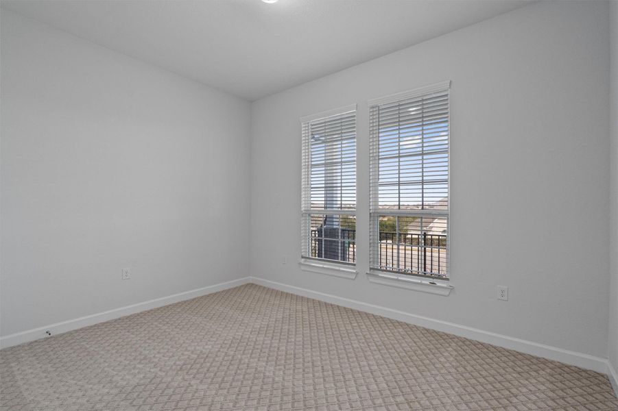 Spare room with baseboards and light carpet Spare room with baseboards and light carpet