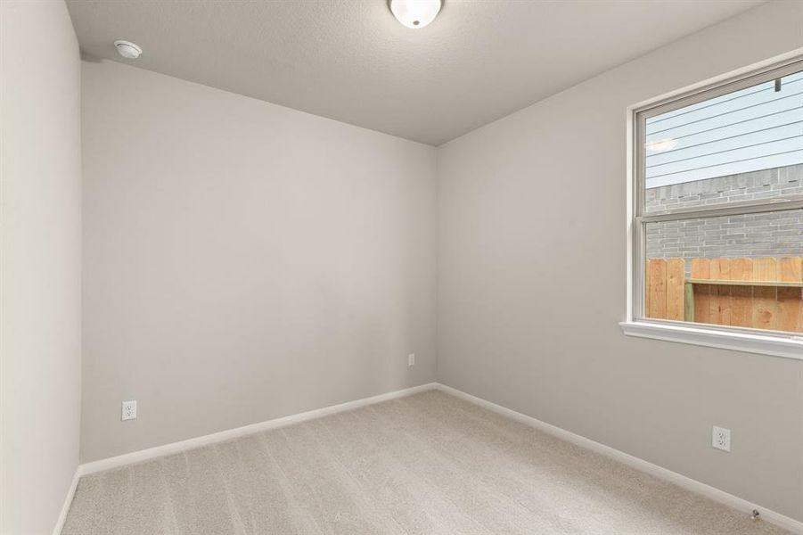 Your secondary bedroom features plush carpet, fresh paint, closet, and a large window that lets in plenty of natural lighting.