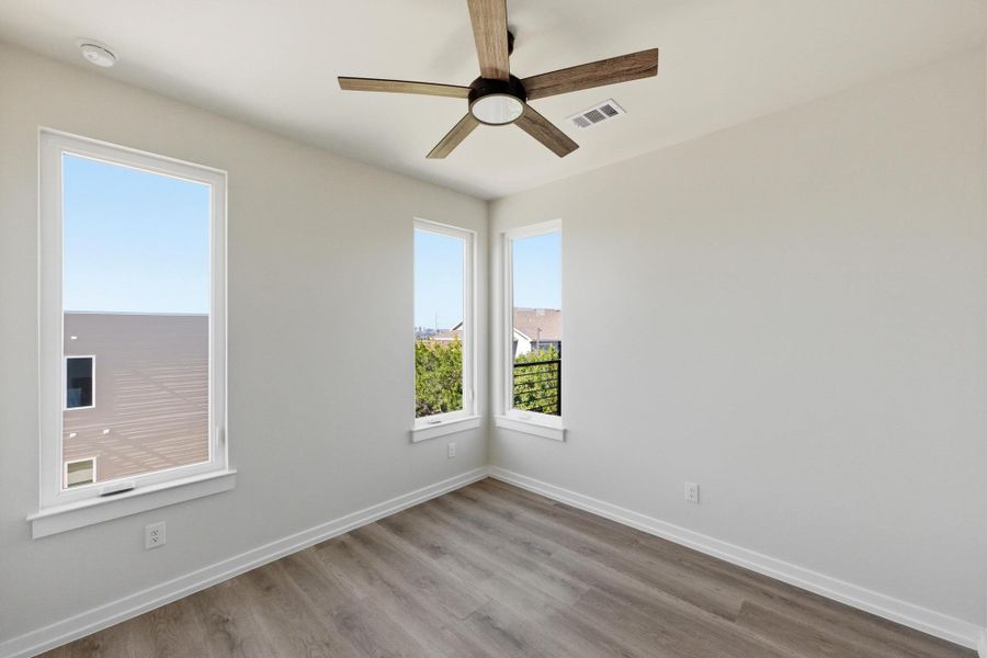 Unfurnished room featuring wood finished floors and ceiling fan