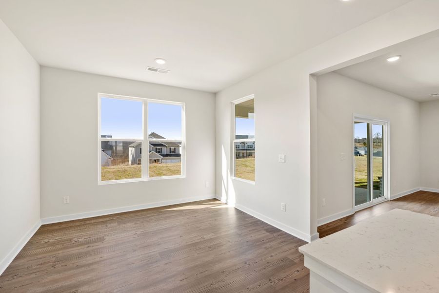 A room with a wood floor and a wood floor with a window. A room with a wood floor and a wood floor with a window.