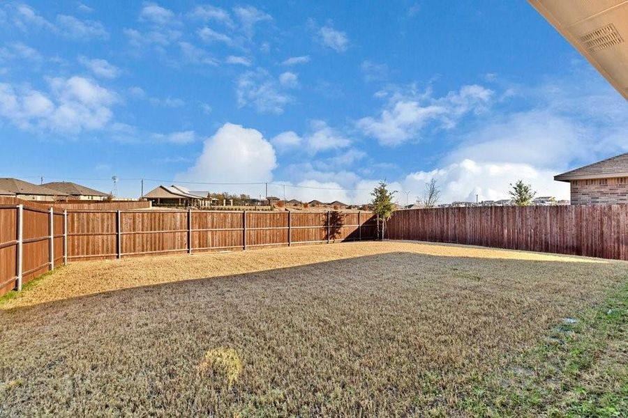 Lovely back yard with grass and expansive views. Backs to the greenbelt and the water feature Lovely back yard with grass and expansive views. Backs to the greenbelt and the water feature