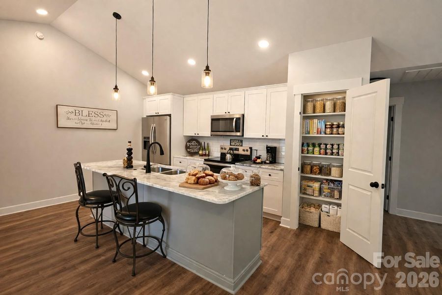 Gourmet Kitchen with marble counters & oversize island & two Pantries. (The refrigerator is virtually staged. Home comes with stove, dishwasher & microwave.)