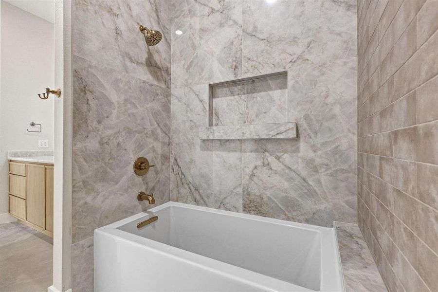 typBathroom featuring a combined bath / shower with
marble appearance and vanitye flooring typBathroom featuring a combined bath / shower with
marble appearance and vanitye flooring