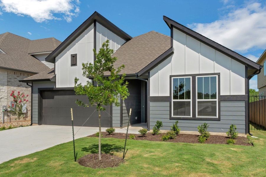 View of front of home featuring board and batten siding, concrete driveway, roof with shingles, and an attached garage View of front of home featuring board and batten siding, concrete driveway, roof with shingles, and an attached garage