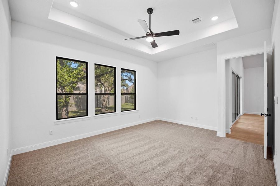 Spare room featuring a raised ceiling, carpet, a ceiling fan, baseboards, and recessed lighting Spare room featuring a raised ceiling, carpet, a ceiling fan, baseboards, and recessed lighting