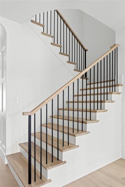 Stairway featuring wood finished floors